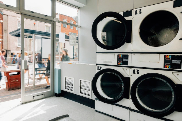 A laundry room with a lot of washing machines offering laundry services and alterations.